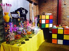 a table covered in candy and candies next to a rubik cube display case