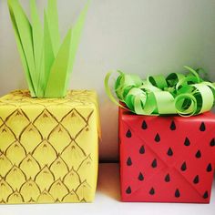 two paper boxes with pineapple and watermelon designs on them, one is yellow and the other is red