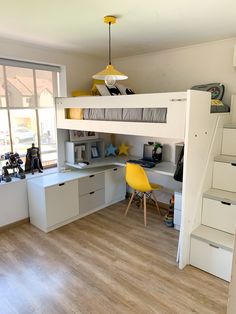 there is a loft bed with stairs and desk in the room that has drawers under it