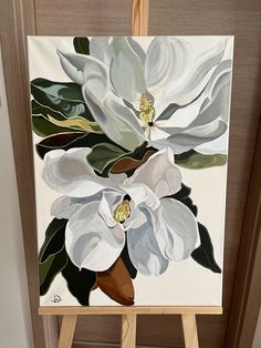 an easel with a painting of white flowers on it