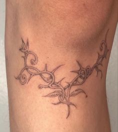 a tattoo design on the side of a woman's lower back neck and leg