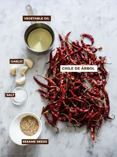 ingredients for chili seasoning on a marble countertop with the words chile de arbol