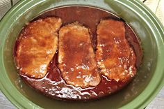 three pieces of meat sitting in a green bowl