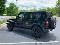 a black jeep parked in a parking lot