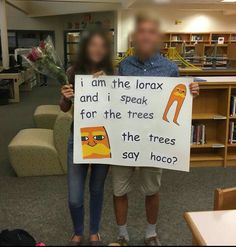 a man and woman holding up a sign that says i am the lorax and speak for the trees