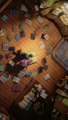 an overhead view of a living room with books scattered on the floor