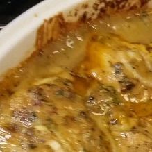 a casserole dish with cheese and onions in it