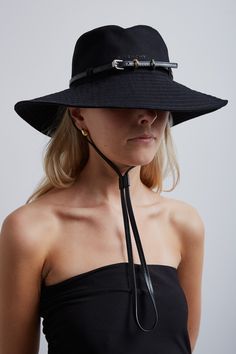 Black cotton bucket hat from Givenchy. The Plage bucket hat is made of cotton canvas with a small Givenchy signature embroidered on the front. It has a thin removable leather belt with Givenchy engraved metal buckles along with a removable and adjustable chinstrap with 4G metal clips. It is complete with golden and silvery-finish metal details.Made in Italy Cotton Bucket Hat, Black Bucket Hat, Black Bucket, Engraved Metal, Metal Engraving, Metal Buckles, Leather Belt, Black Cotton, Givenchy