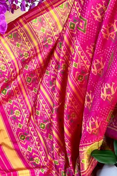 This beautiful single ikkat Patola saree in pink color is woven in narikunj design. The borders are woven in antique gold tissue with the ikkat design, and the pallu has a beautiful floral patterns. Approximate Length 6.5 mtrs (inclusive of blouse length)Height - 46 - 50" Saree comes with fall, picot and tassels done. Blouse piece is cut. Approximate weight - 1.2 lbs Kindly Note : The colors you see on your device may vary due to the color reproduction, brightness and resolution of individual devices. If you'd like more clarity before your purchase, please contact our support team. Pink Bohemian Pre-draped Saree For Festivals, Pink Slub Silk Dupatta For Transitional Season, Pink Bandhani Print Pre-draped Saree For Festivals, Multicolor Ikat Print Pre-draped Saree For Navratri, Pink Slub Silk Pre-draped Saree With Dupatta, Pink Bohemian Pre-draped Saree For Festive Occasions, Bohemian Pink Pre-draped Saree For Festive Occasions, Festive Pink Bohemian Pre-draped Saree, Pink Bandhani Print Chanderi Pre-draped Saree