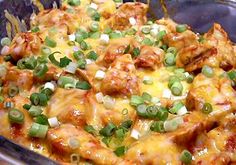 a casserole dish with meat, cheese and green onions