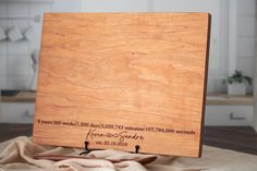 a wooden cutting board sitting on top of a table