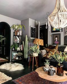 a living room filled with furniture and lots of plants