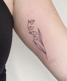 a woman's arm with a flower tattoo on the left side of her body