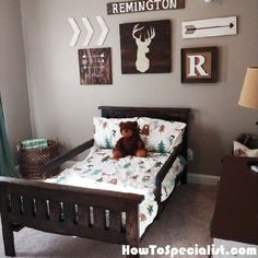 a teddy bear sitting on top of a bed in a room with pictures above it