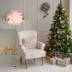 a living room with a christmas tree and a chair