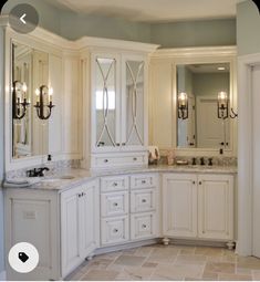 a large bathroom with double sinks and mirrors