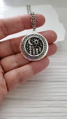 Moon Sun Necklace Crescent moon and sun locket. A creative piece with a nice celestial fantasy and Pine Tree Nature vibe. Could be a great addition to your jewelry collection or gift to that special someone in your life.   Chain: ~ Silver Plated YOU CHOOSE YOUR CHAIN LENGTH during checkout ☻More Lockets Here: https://www.etsy.com/shop/FashionCrashJewelry/search?search_query=lockets&order=date_desc&view_type=gallery&ref=shop_search ☻Link to The ENTIRE SHOP: https://www.etsy.com/shop/FashionCrashJ Nature-inspired Moon Charm Necklace As A Gift, Nature-inspired Moon Charm Necklace For Gift, Nature-inspired Necklace With Moon Charm Round Pendant, Celestial Locket Necklace For Gifts, Silver Moon-shaped Locket Jewelry, Moon Necklace Silver, Silver Lockets, Jewelry Tree, Silver Moon