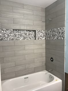 a white bath tub sitting inside of a bathroom