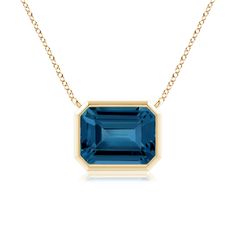 This classic east west London blue topaz pendant is crafted in 14k yellow gold. The emerald cut greenish blue gemstone is mounted in a horizontal bezel setting. Blue Topaz Pendant, Topaz Pendant, Greenish Blue, West London, London Blue Topaz, Blue Gemstones, East West, London Blue, Fine Jewellery Necklace