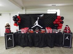 an air jordan themed birthday party with black and red balloons