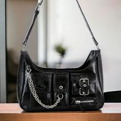 A Stylish Black Hobo Handbag Purse! Has An Adjustable Shoulder Strap To Ensure A Very Comfortable Carry. Rock The Chains, Multiple Front Pockets And Belt Buckle Pocket. Very Cool Bag! 17l Strap Vegan Leather With Lined Interior. Top Zip Closure. Silver Toned Hardware. 12.5l X 6h X 4w Leather Lavish Glamour 60s 70s 80s 90s Glitzy Modern Spring Summer Fall Winter Cruise Highly Visible Artsy Sexy Flashy Glamorous Versatile Casual Boho Free Spirit Hippie Festival Retro Flirty Gypsy Goth Grunge Styli Winter Cruise, Cool Bag, Lounge Party, Hobo Handbag, Hippie Festival, Goth Grunge, Boho Casual, Hobo Handbags, Shoulder Handbag