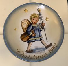 a christmas plate with an angel holding a guitar