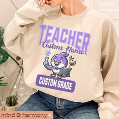 Celebrate the start of a new school year with our Personalized Matching Teacher Sweatshirt. This cozy, custom teaching sweater features a vibrant rainbow design, perfect for brightening up the first day of school. A thoughtful Back to School Appreciation Gift, this sweatshirt can be customized with your name and grade, making it an ideal addition to your Teach Team's wardrobe. Stand out in style and show your teaching pride with this unique, personalized piece. Perfect for creating a unified, ch Customizable Crew Neck Sweatshirt For School, Casual Customizable Sweatshirt For School, Wardrobe Stand, Personalized Matches, Teacher Sweatshirt, Rainbow Design, Favorite Sweater, New School Year, Fitted Sweater