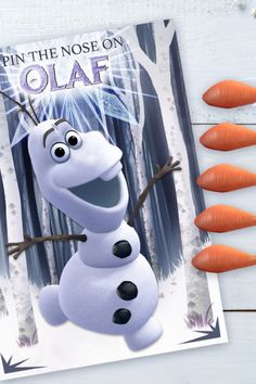 there are carrots on the table next to an image of frozen princess snowman