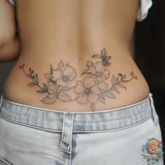 a woman's lower back with flowers on her stomach and the bottom part of her body