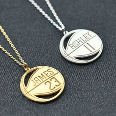 two necklaces with the same name and number on them, one has a basketball hoop