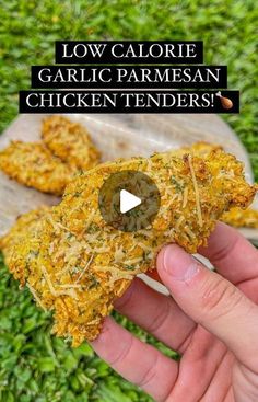 someone is holding up some chicken tenders in their hand with the text low calorie garlic parmesan chicken tenders