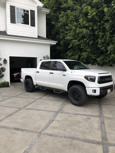 a white truck parked in front of a house