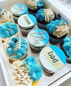 a box filled with blue and white cupcakes