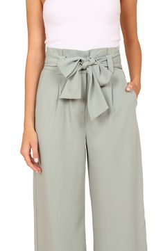 Wide legs punctuate these tailored pants designed with a drapey tie belt and crisp pleats. Zip fly with hook-and-bar closure Front slant pockets Removable tie belt Lined 100% polyester Hand wash, dry flat Imported Chic Paperbag Waist Pants For Work, Paperbag Waist Pants With Tie For Workwear, Chic Paperbag Waist Pants For Business Casual, Chic Business Casual Paperbag Waist Pants, Chic Paperbag Waist Bottoms For Workwear, Chic Paperbag Waist Bottoms For Office, Business Casual Paperbag Waist Pants For Spring, Spring Solid Wide Leg Pants With Tie Waist, Chic Paperbag Waist Bottoms With Tie