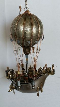 an antique hot air balloon on display in a white room with lots of other items