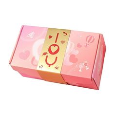 a pink box with gold foil on the top and red lettering that says i love you