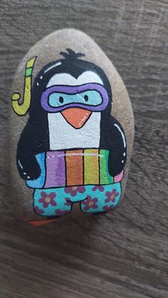 a rock with a penguin painted on it