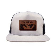 Colorado Elevation mountains faux leather patch in rawhide. Available in silver gray or black. Flat bill cotton twill front. Mesh back with adjustable snapback Urban Trucker Hat With Logo Patch For Outdoor, Gray Snapback Hat With Flat Bill For Outdoor, Outdoor 5-panel Baseball Cap With Leather Patch, Gray Flat Brim Hat For Outdoor Activities, Made In Usa Snapback Baseball Cap For Outdoor, Outdoor Flat Brim Hat With Logo Patch, Gray Snapback Hat With Curved Brim For Outdoor, Adjustable Baseball Cap Made In Usa For Outdoor, Gray Flat Bill Trucker Hat For Outdoor Activities