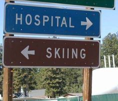 street signs pointing in different directions to hospital, skiing and the rest of the road