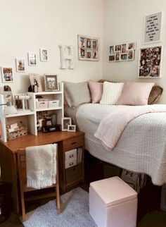 a small bedroom with a bed, desk and pictures on the wall above it's headboard