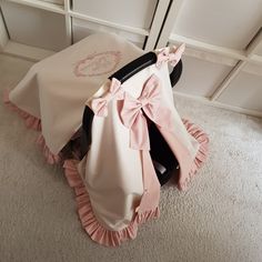 a chair with a pink bow on it