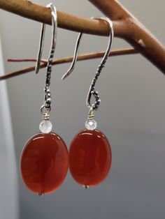 "This Carnelian oval beads are 18x12mm, on top of them are 3mm round faceted Rainbow Moonstone.  Handmade sterling silver artisan ear hooks are 25mm.  Total earrings length is  just under 2\"  ( 1 15/16\") Link to the shop  https://www.etsy.com/shop/CrystalRise" Adjustable Carnelian Earrings With Natural Stones, Silver Carnelian Jewelry With Ear Wire, Carnelian Round Earrings With Ear Wire, Oval Carnelian Jewelry With Natural Stones, Carnelian Earrings, Oval Beads, Beaded Jewelry Patterns, Jewelry Patterns, Handmade Sterling Silver