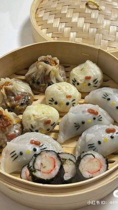 an assortment of sushi rolls with hello kitty faces on them in a bamboo steamer