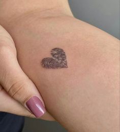 a woman's arm with a fingerprint in the shape of a heart