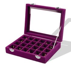 an open purple velvet jewelry box with compartments