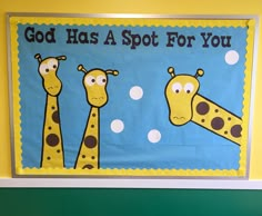 a bulletin board with three giraffes painted on it's sides and the words god has a spot for you