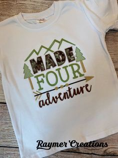 a white shirt with the words made four adventure printed on it, and an arrow