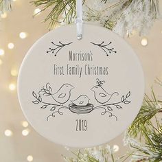 a personalized ornament hanging from a christmas tree