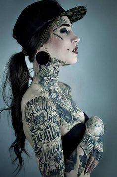 a woman with lots of tattoos on her body