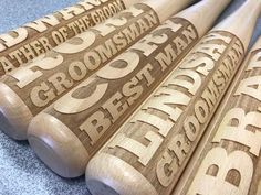 four wooden baseball bats with the names of different teams on them, all lined up together